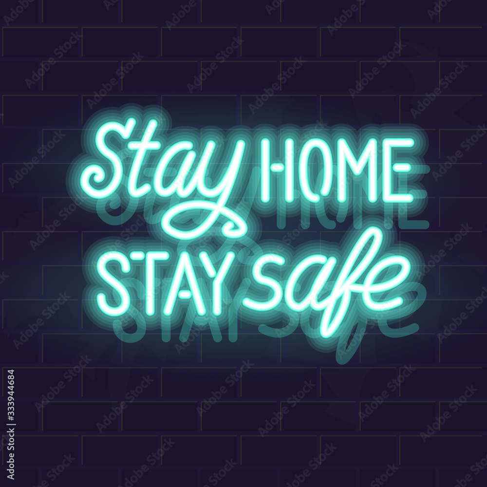 Neon stay home stay safe handwritten lettering. Glowing vector motivation typography. Fluorescent letters on dark brick wall background.