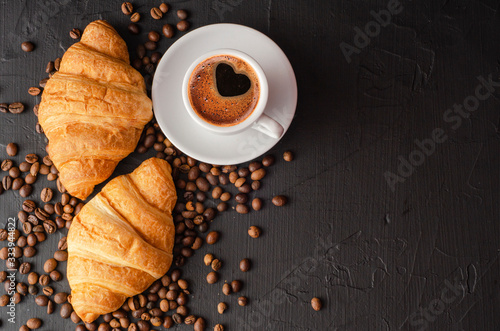 Coffee white cup  croissants on dark  background. Breakfast concept