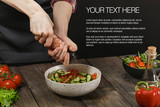 Woman salting fresh vegetable salad. Female hands. Diet concept for healthy lifestyle with sample text.