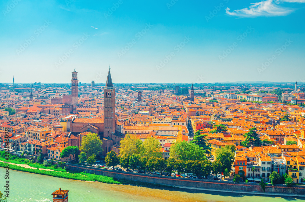 Obraz premium Aerial view of Verona historical city centre, Adige river, church Basilica di Santa Anastasia tower, medieval buildings with red tiled roofs, Veneto Region, Italy. Verona cityscape, panoramic view.