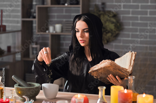 Female alchemist making elixir in laboratory