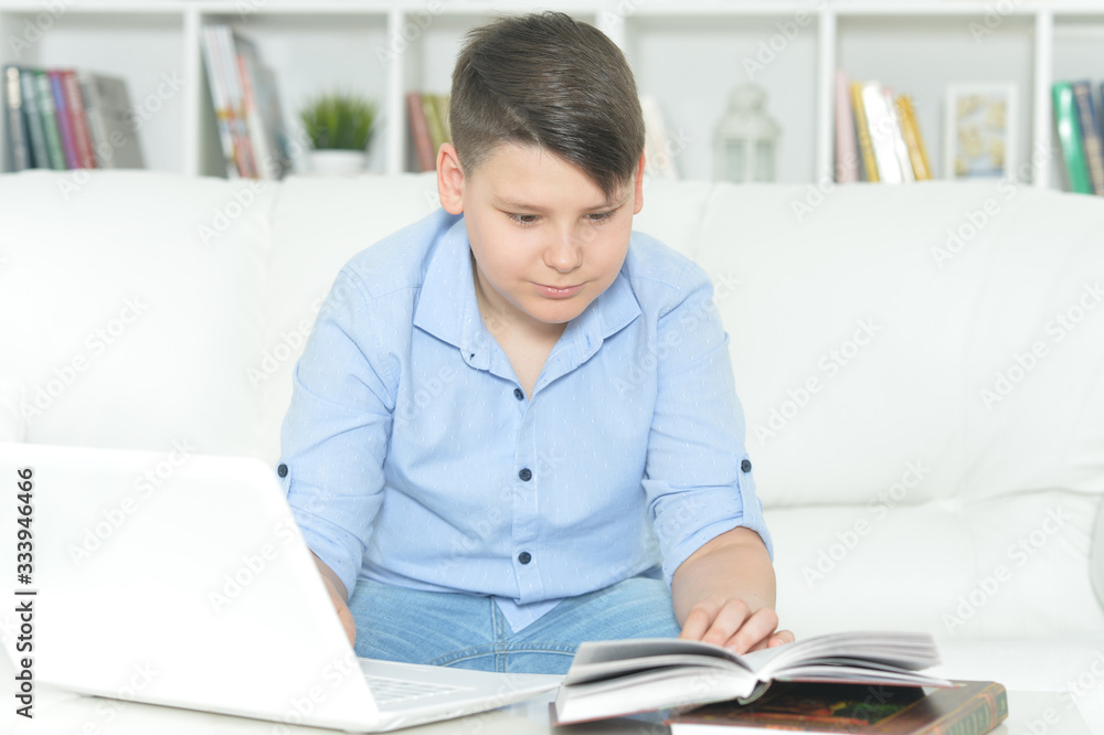 Portrait of boy doing homework with laptop Portrait of boy doing homework with laptop