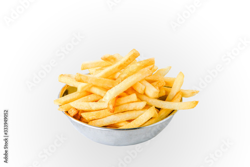 Delicious French fries on a separate stainless steel cup on a white background.