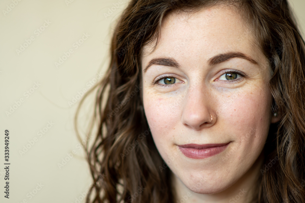 A close up portrait of a beautiful young woman with green eyes and brown hair A close up portrait of a beautiful young woman with green eyes and brown hair