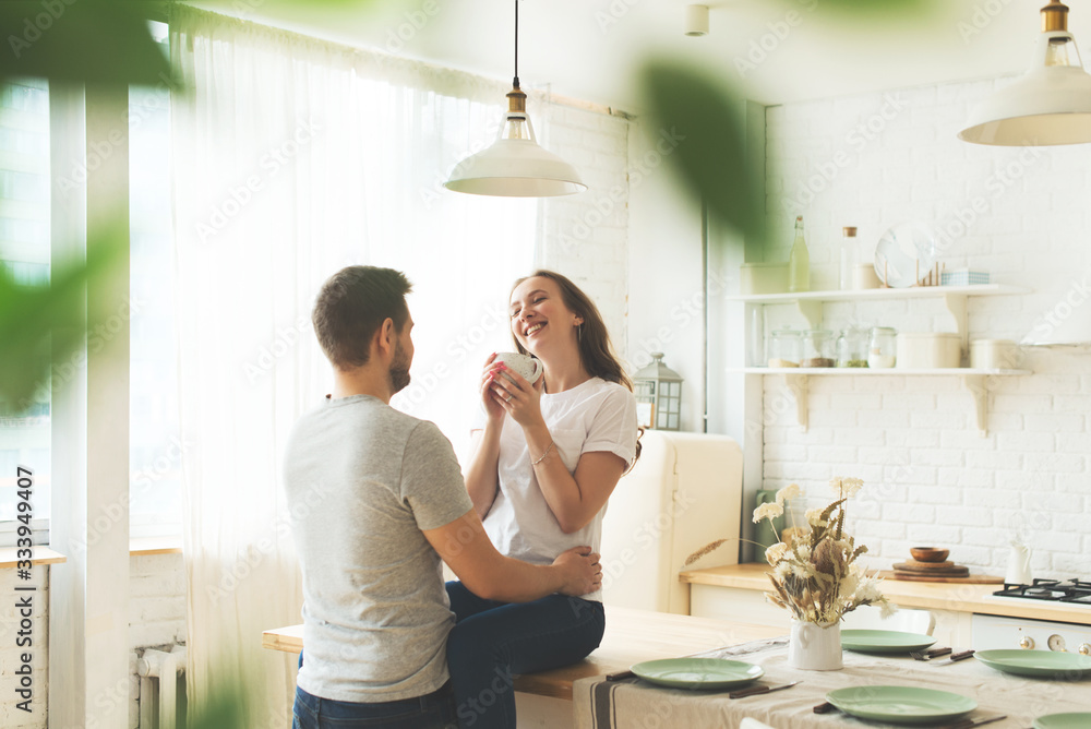 Lifestyle consept at home with couple young men and woman in kitchen Lifestyle consept at home with couple young men and woman in kitchen