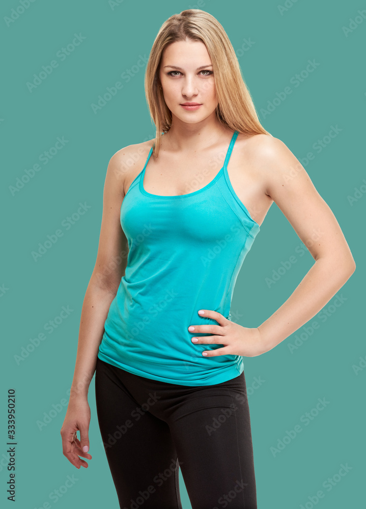 fitness woman. Young sporty Caucasian female model isolated on background jungle shade green color fitness woman. Young sporty Caucasian female model isolated on background jungle shade green color