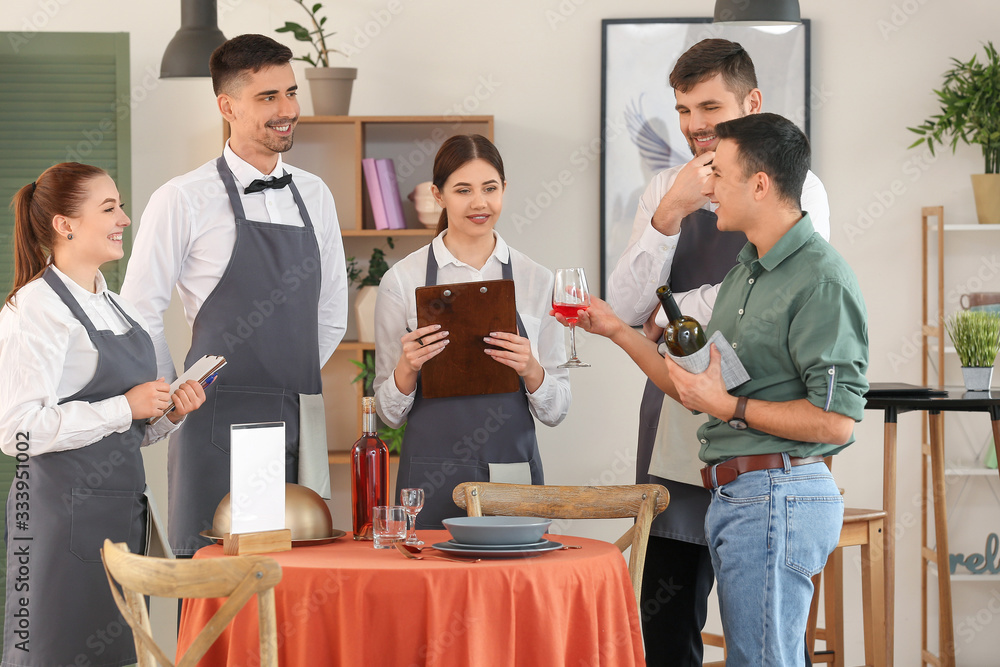 Fototapeta premium Young people attending professional waiter courses
