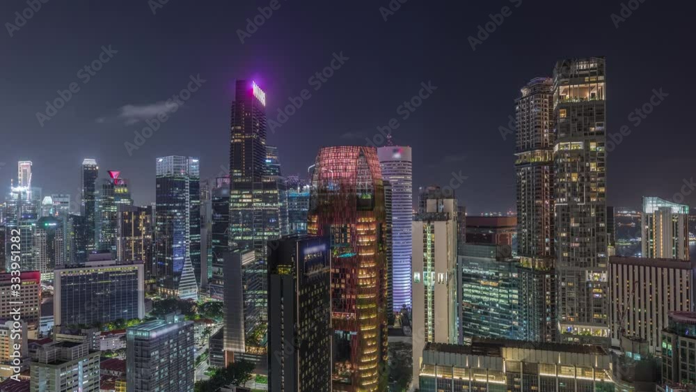 Aerial cityscape of Singapore downtown of modern architecture with illuminated skyscrapers night timelapse, view from above from skybridge viewpoint with glowing windows in towers Aerial cityscape of Singapore downtown of modern architecture with illuminated skyscrapers night timelapse, view from above from skybridge viewpoint with glowing windows in towers