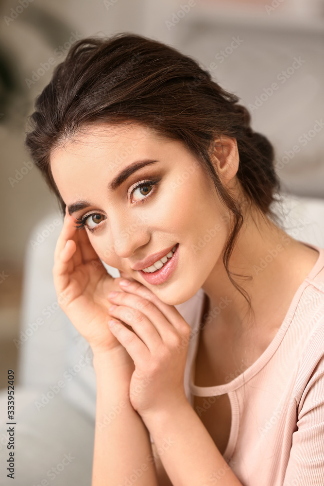 Fototapeta premium Young woman with beautiful hairdo at home