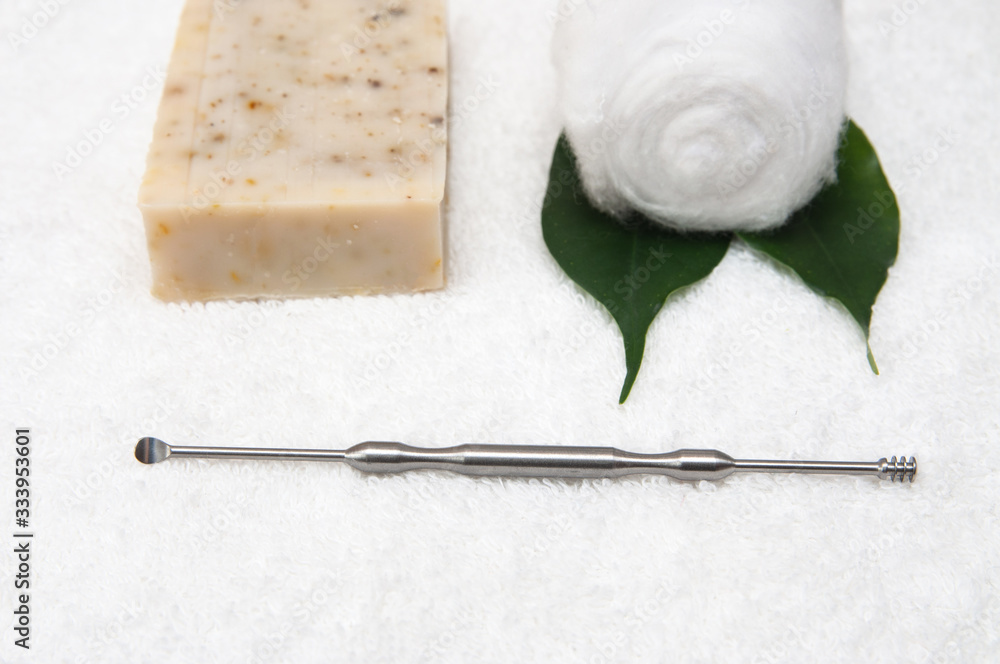 Mimikaki - a metal stick for cleaning ears, soap and cotton roll on a ...