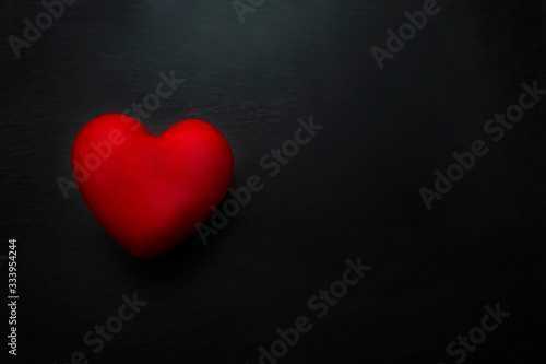 Red heart on black background, health care, donate and family insurance concept,world heart day, world health day, CSR responsibility, adoption foster family