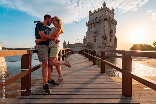 Couple in love on a small bridge leading to tower of Belem in Lisbon photo
