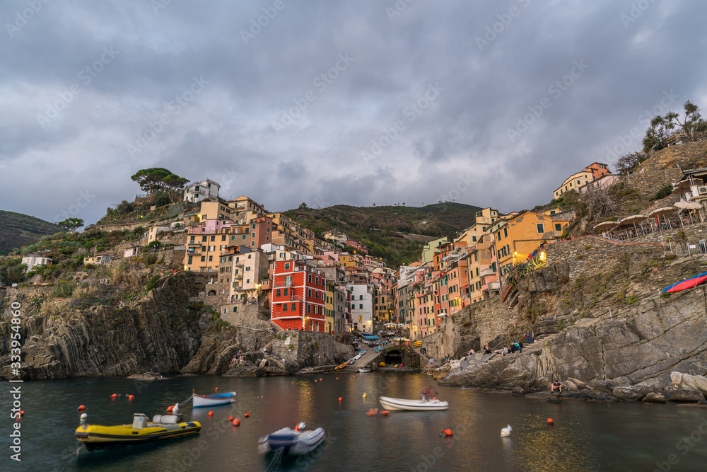 Riomaggiore town on Italian coastline at sunset in Cinque Terre, Italy