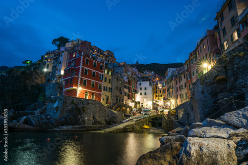 Riomaggiore town on Italian coastline at night in Cinque Terre, Italy