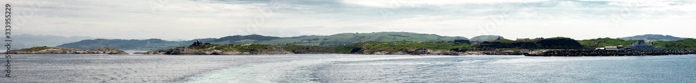 Panorama of Rennesoy island coastline from a ferry departed Mortavika port, Norway, May 2018