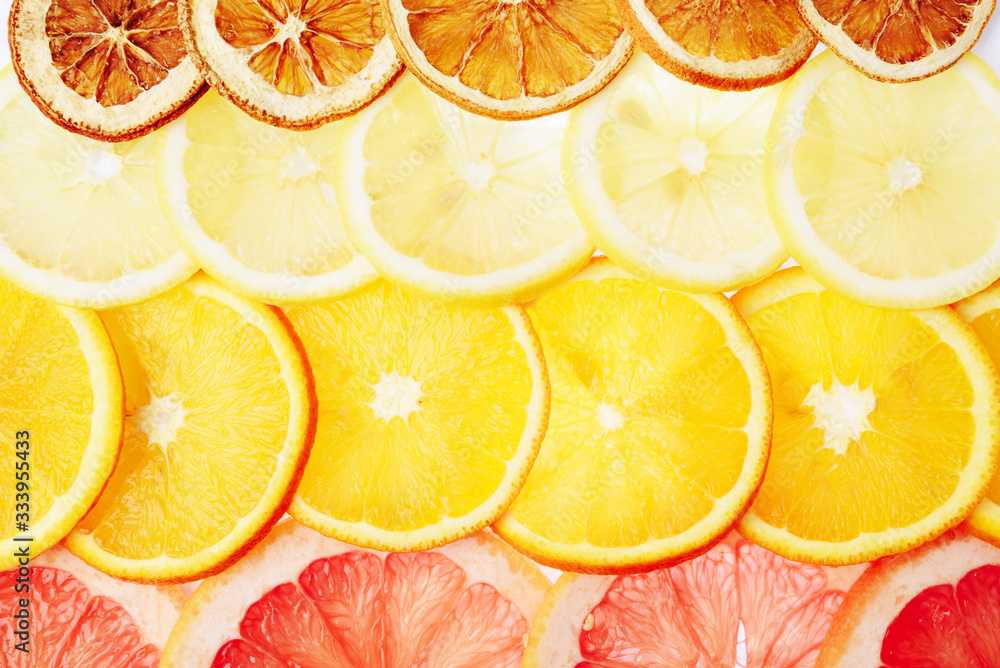 translucent slices of lemon, orange and grapefruit on a white background, citrus fruit slices, summer mix translucent slices of lemon, orange and grapefruit on a white background, citrus fruit slices, summer mix
