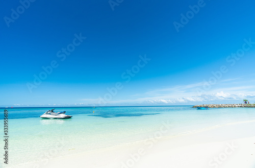 Beautiful tropical beach and blue sky in Maafushi Island, Maldives with jet ski