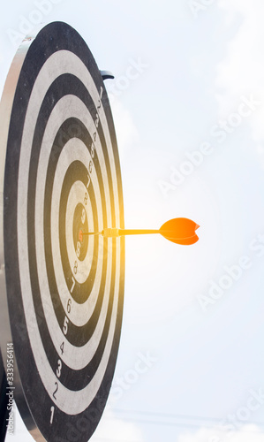 Dart on Dartboard score Achieve winner on target for business concept 