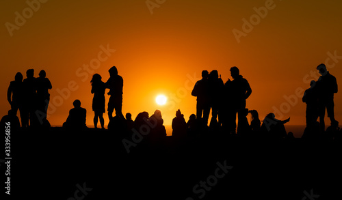 Silhouettes of people looking at sunset in Algarve