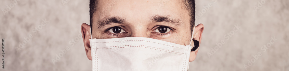 Close up portrait of handsome man in a protective medical mask Close up portrait of handsome man in a protective medical mask