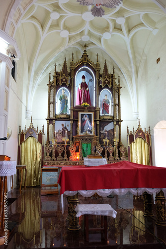 Main altar at St. Blaise Catholic Church in Gandaulim, Goa, India photo