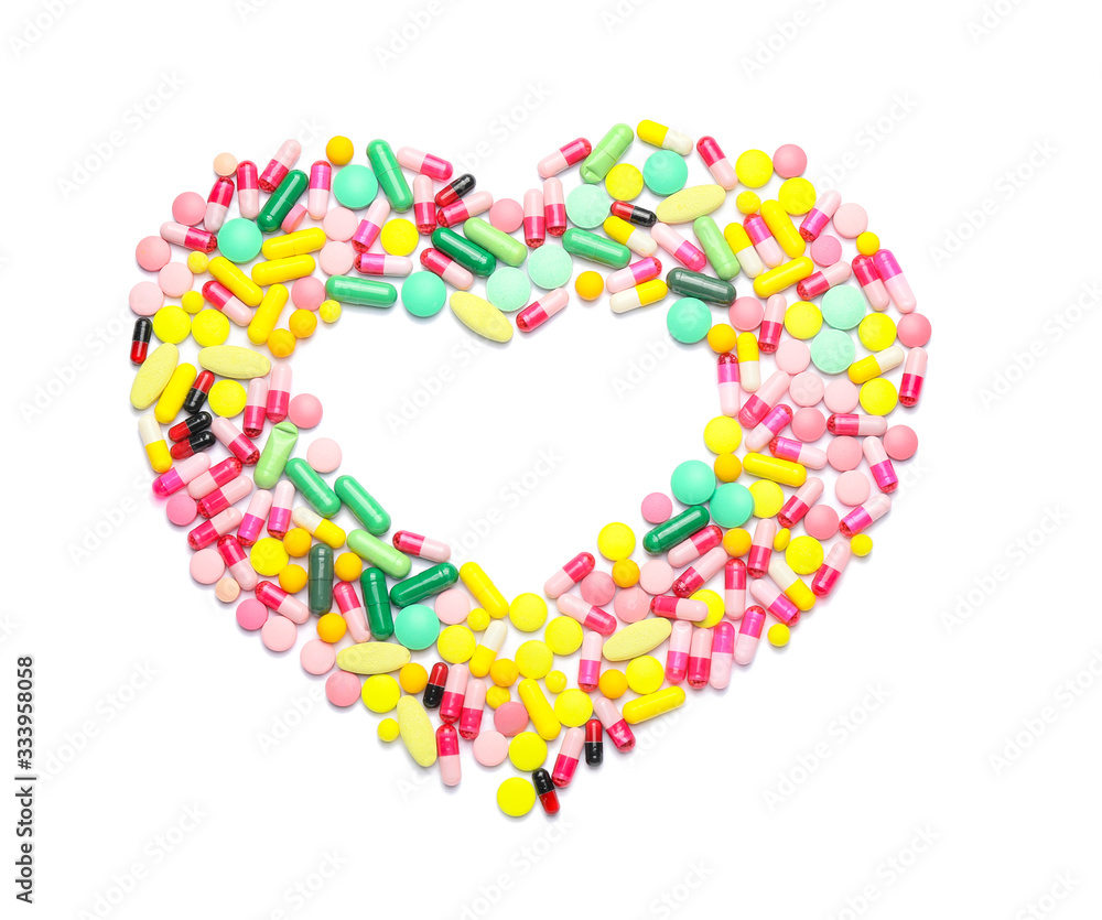 Heart made of pills on white background