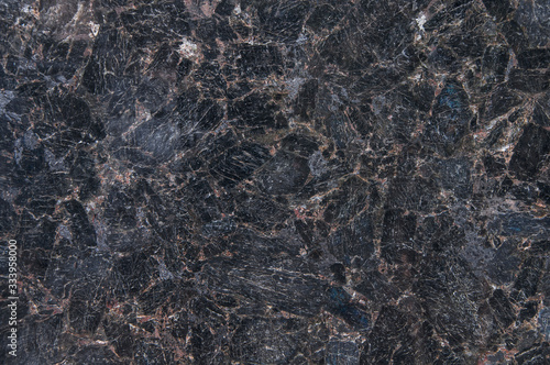 Natural stone granite labradorite. Black granite texture, granite surface and background. Material for decoration, texture, design. photo