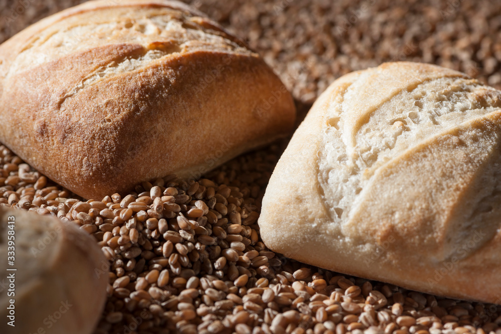 three bread rolls on grain