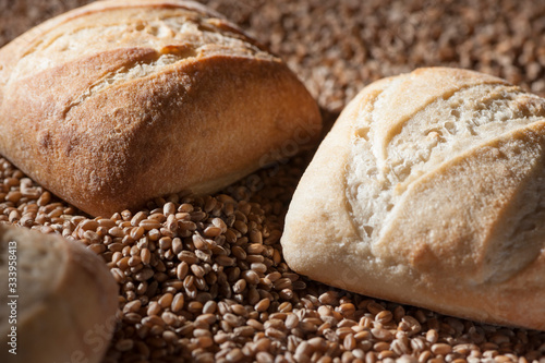 three bread rolls on grain