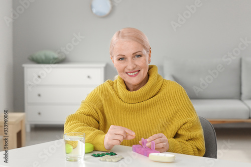 Mature woman taking pills a...