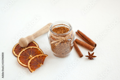 Cinnamon sticks and star anise on brown sugar with shallow depth of field on white background. Baking ingredients