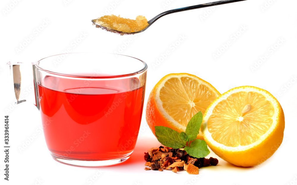 Cup of fruit tea, half pieced lemon, heap of dried tea and teaspoon of honey isolated on white background. Cup of fruit tea, half pieced lemon, heap of dried tea and teaspoon of honey isolated on white background.