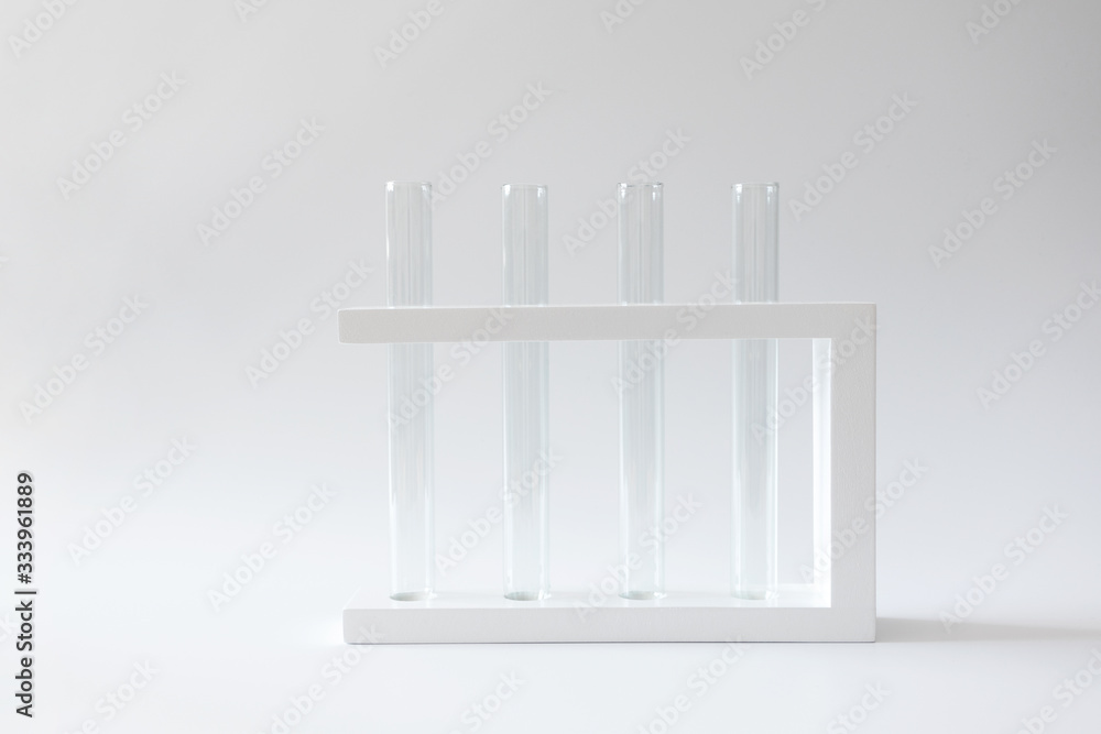 Empty clean test tubes in rack on white background with copy space. Concept laboratory research and scientific experiment Empty clean test tubes in rack on white background with copy space. Concept laboratory research and scientific experiment