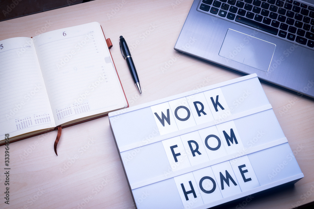 Workspace table with a lichtbox with the words WORK FROM HOME. Workspace table with a lichtbox with the words WORK FROM HOME.