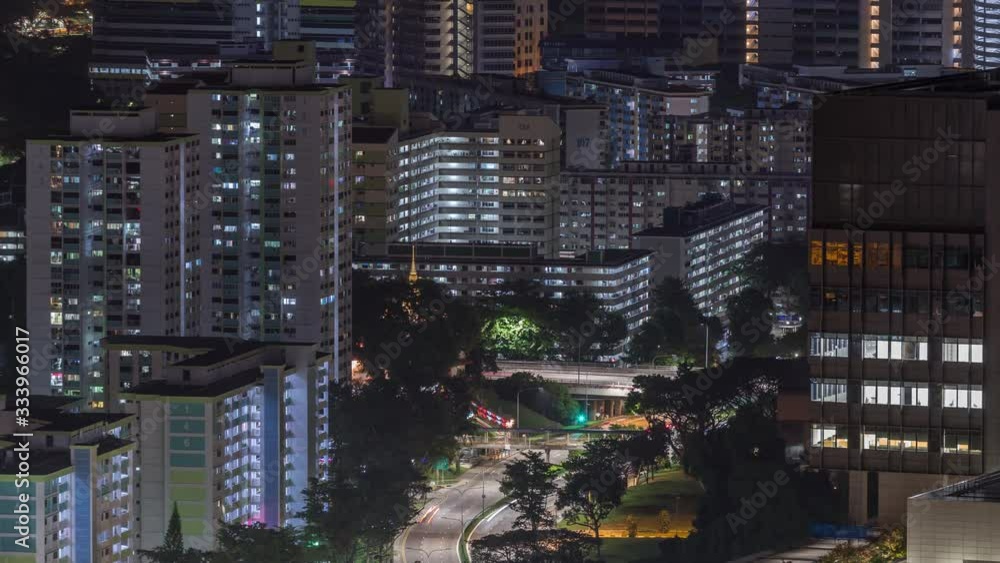 Aerial skyline with apartment buildings and skyscrapers of Singapore night timelapse. Traffic on streets. View from skybridge vewpoint Aerial skyline with apartment buildings and skyscrapers of Singapore night timelapse. Traffic on streets. View from skybridge vewpoint