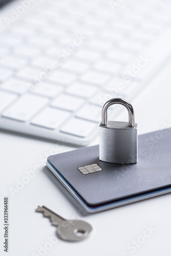 Finance. Security. Bank card with lock and key on a white table. Data security