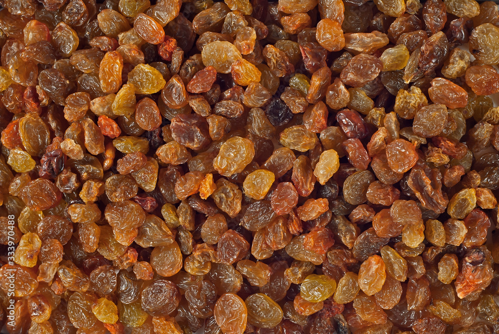 Texture of yellow and orange raisins. Dry raisins on the pile. Texture of yellow and orange raisins. Dry raisins on the pile.