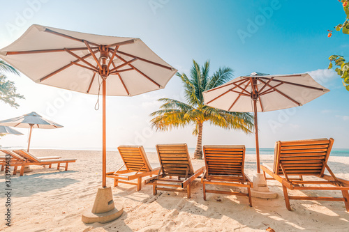 Beach beds and umbrellas on a tropical island. family vacation or summer holiday, beach landscape and shoreline, sunny weather, exotic destination. © icemanphotos