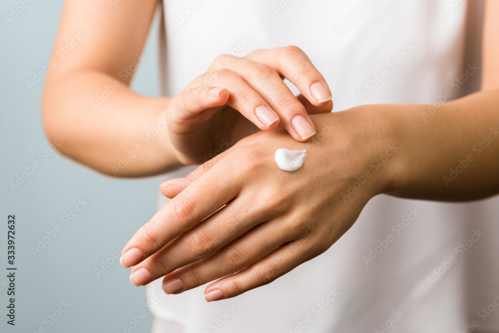 hand skin protection. close up view of woman hand applying moisturizer hand skin protection. close up view of woman hand applying moisturizer