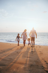 Holiday travel concept, Summer vacations. Happy family are having fun on a tropical beach in sunset.