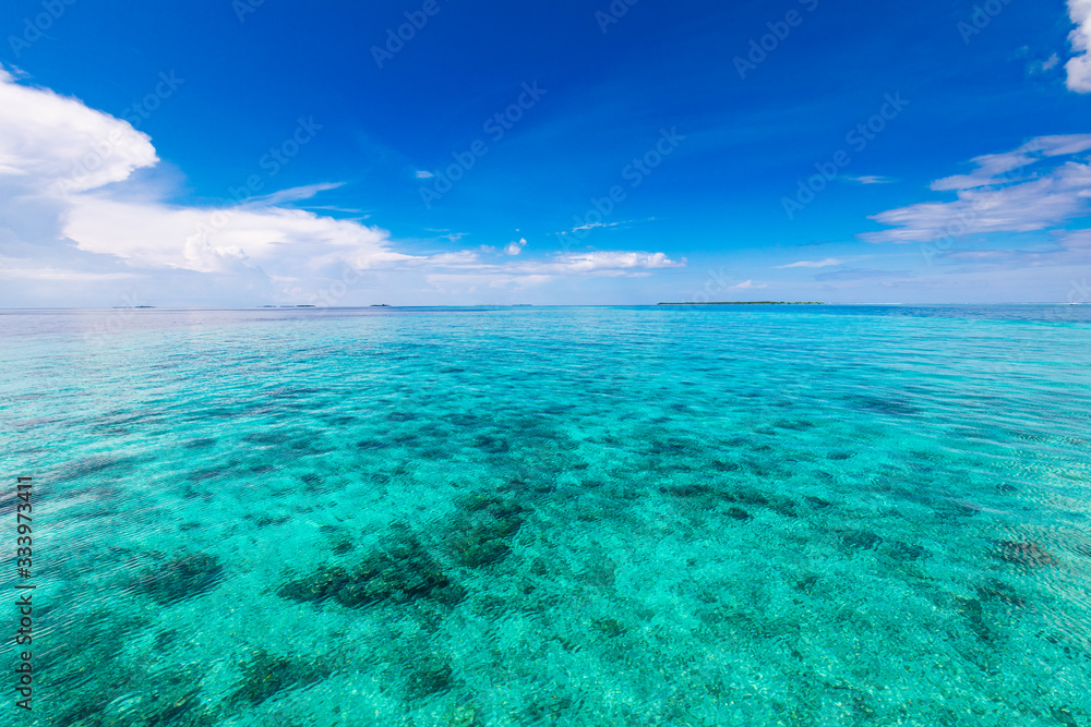 Turquoise tropical sea. Outdoor tropical summer sea paradise. Heaven view of deep transparent ocean. Sunshine reflection on a calm summer ocean. Tranquility of turquoise water