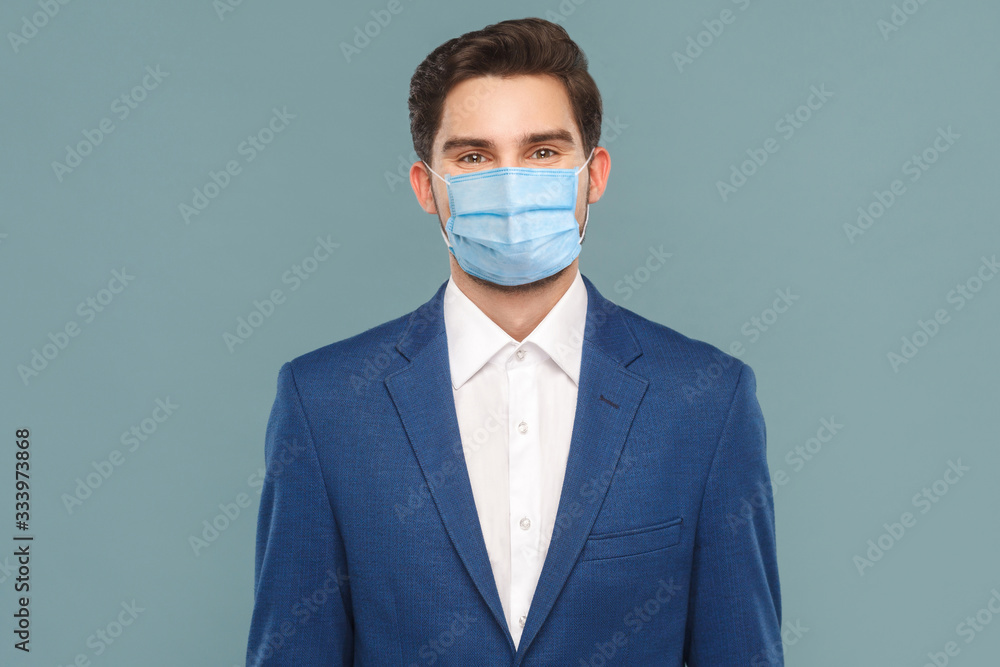 Handsome young businessman toothy smiling. Business people concept, richly and success. Indoor, studio shot on light blue background Handsome young businessman toothy smiling. Business people concept, richly and success. Indoor, studio shot on light blue background