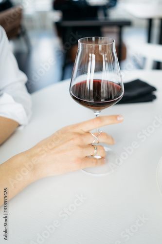 Female holding glass of wine in the bar