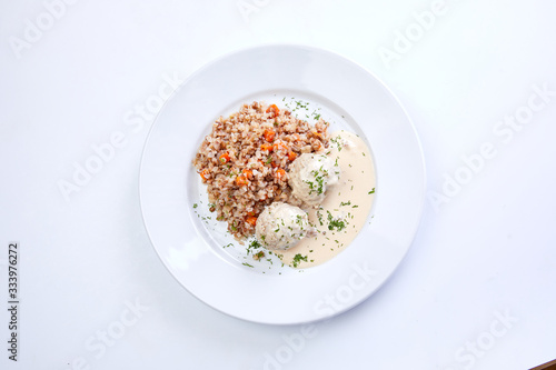 meatballs with buckwheat and sauce on the white