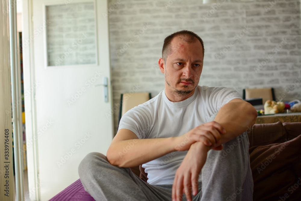 Fototapeta premium miserable depressed man sitting and thinking. Feeling hopeless.