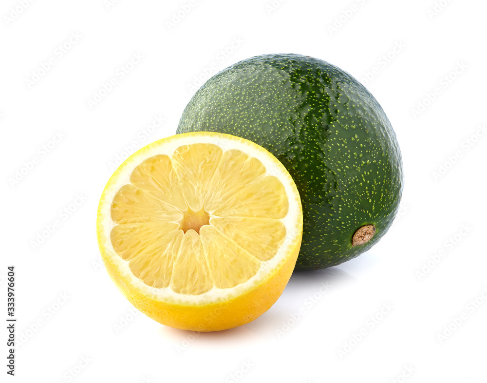 Whole green avocado with lemon isolated on white background Whole green avocado with lemon isolated on white background