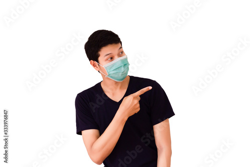 An Asian man wearing a mask and pointing a billboard
