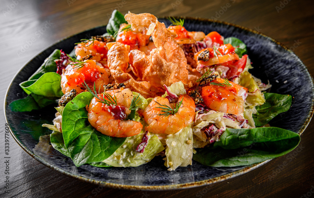 Fresh salad plate with shrimp, tomato, spinach, cabbage and Tangerine Jam in plate on wooden table background Fresh salad plate with shrimp, tomato, spinach, cabbage and Tangerine Jam in plate on wooden table background