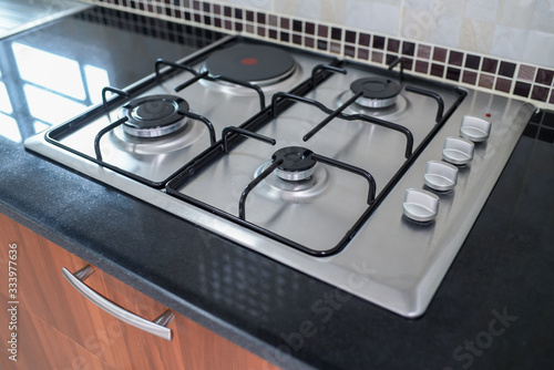Modern gas stove on a black background in the kitchen