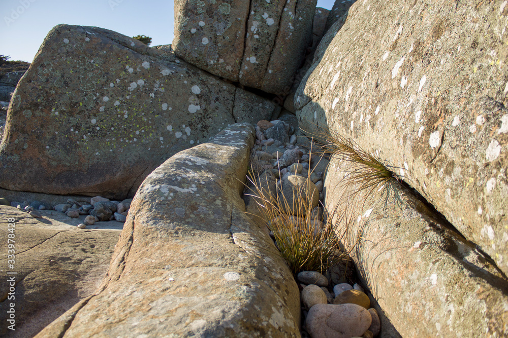 Stones near the water and the blue sky Stones near the water and the blue sky
